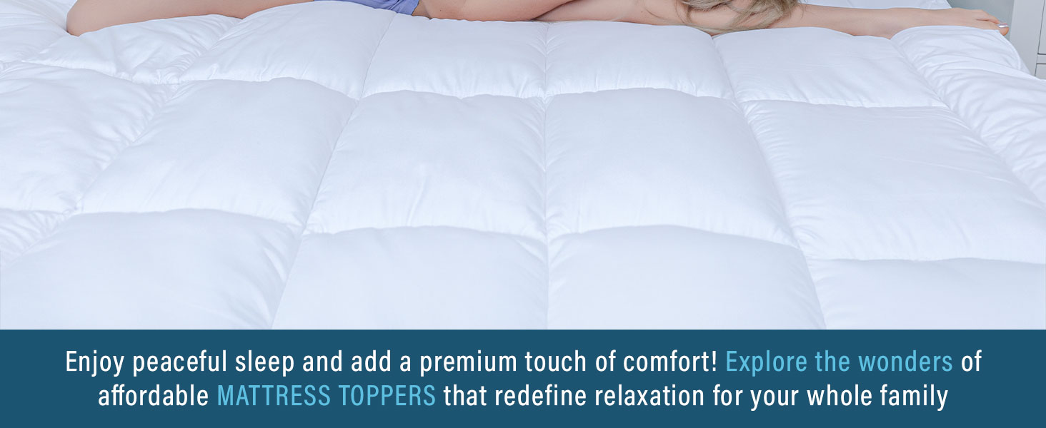 White quilted mattress topper or pad shown in close-up detail, displaying plush cushioned texture and stitched pattern.